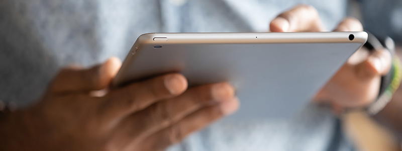 Person reading information on tablet