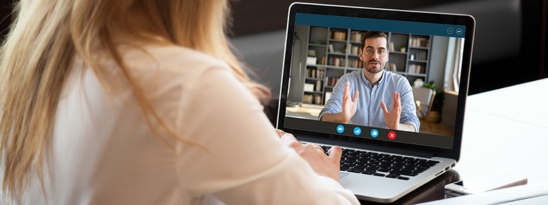Woman watching webinar on laptop